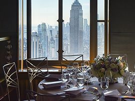 An ornate table setting at The Society of MSK’s Fall Lunch, in a ballroom overlooking the New York City skyline.