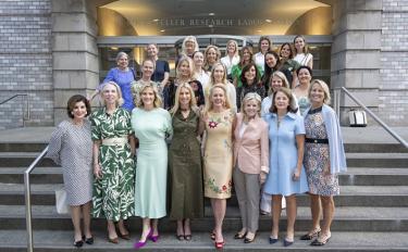 Twenty-five members of The Society of the MSK stand in rows on the steps of our Rockefeller Research Laboratories.