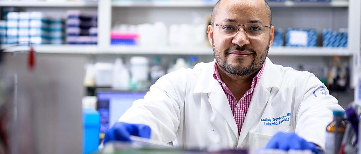 MSK scientists in the lab faces the camera, smiling