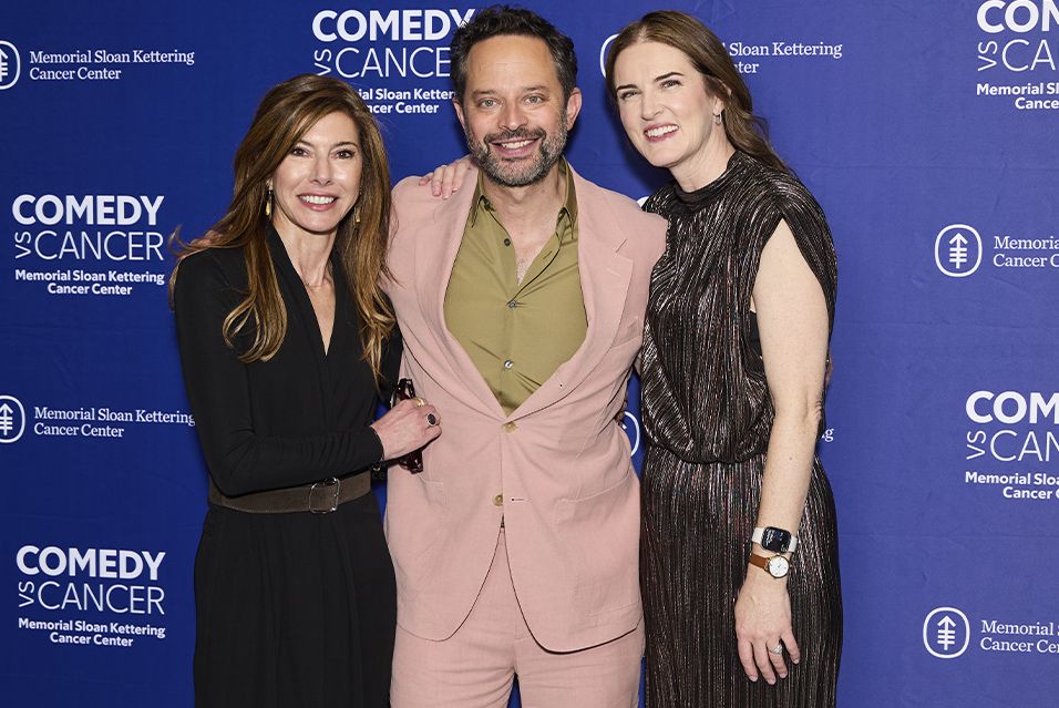 From left to right: Niccole Kroll, Nick Kroll, and Jennifer Rogers Carlock in front of a Comedy vs Cancer backdrop.