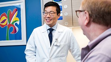 An MSK physician and a patient in a treatment room.