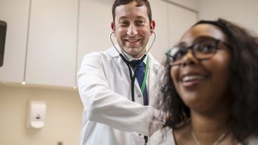 An MSK doctor with a patient in an exam room.
